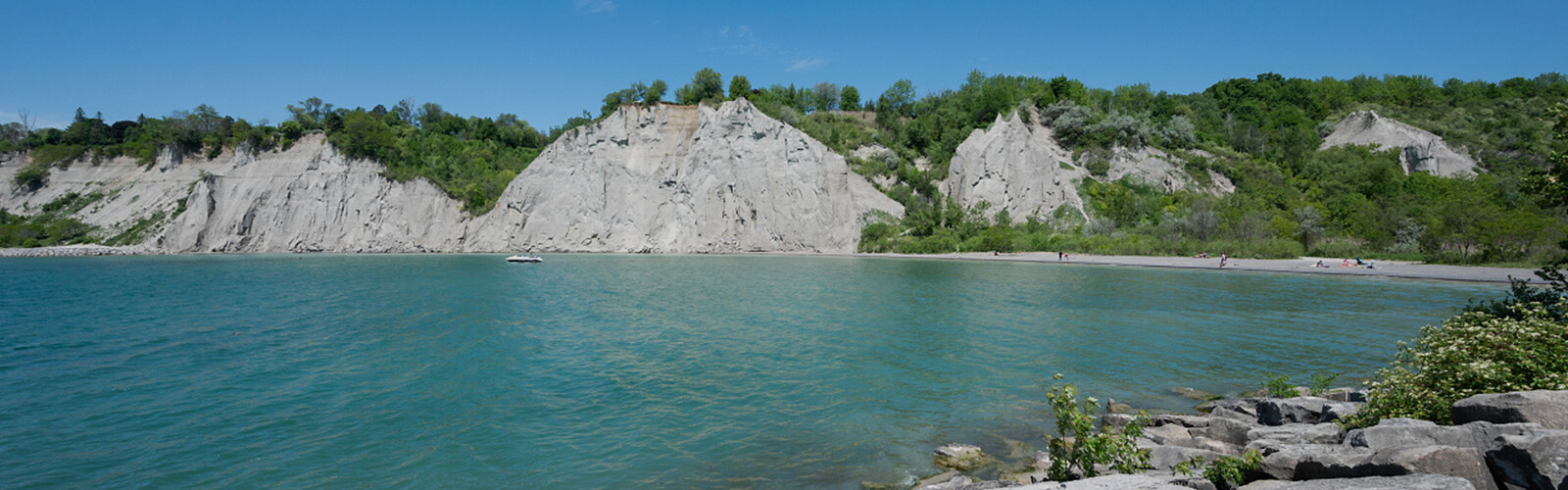 Bright blue water with the Scarborough Bluffs in the background