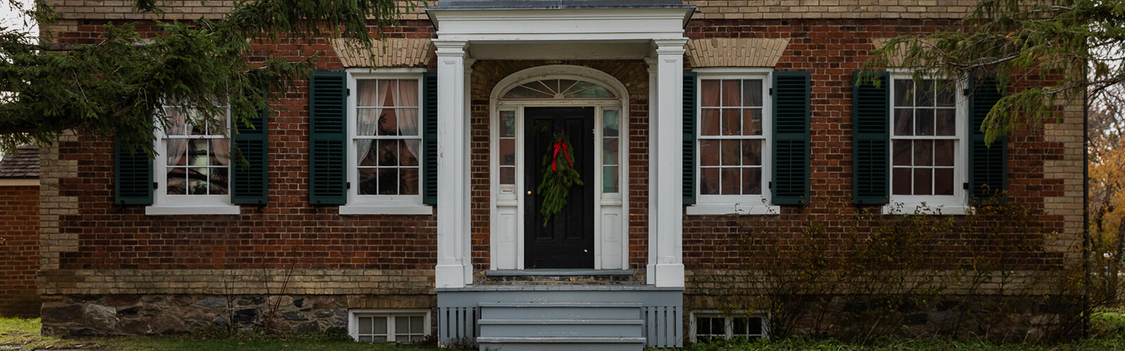 The front of Gibson House which is in the Georgian Revival style.