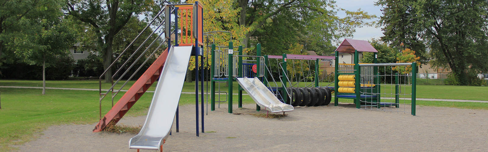 Children's playground area within a lush green park